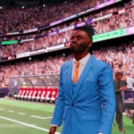 Un entraîneur en costume dans le stade, capture de Football Manager 27